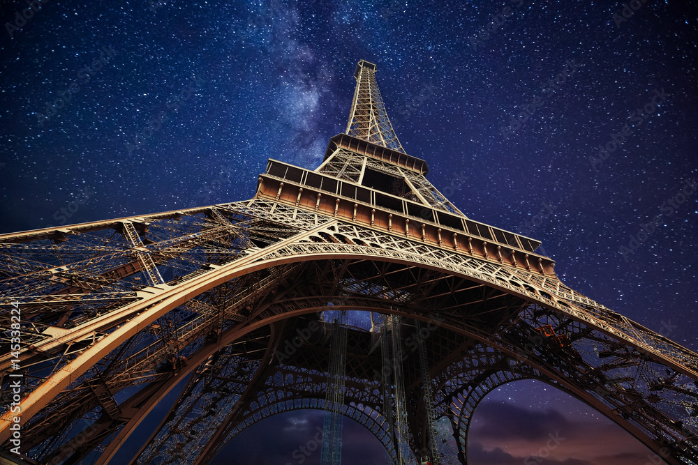 The Eiffel Tower at night in Paris, France - obrazy, fototapety, plakaty 