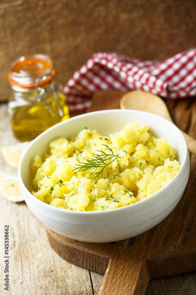 Potato salad with fresh dill in white bowl