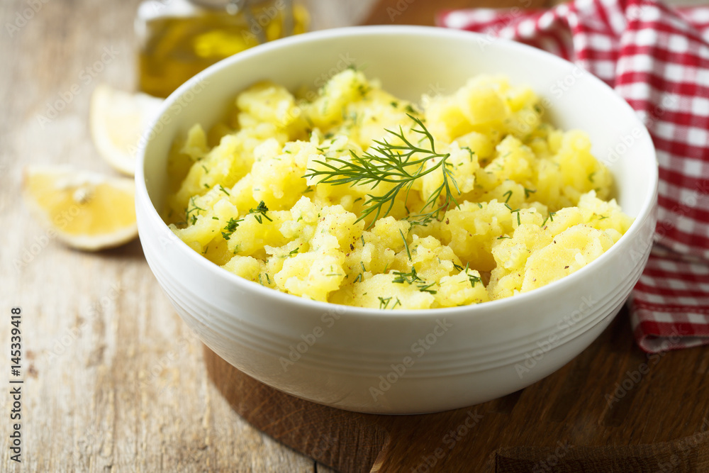 Potato salad with fresh dill in white bowl Potato salad with fresh dill in white bowl