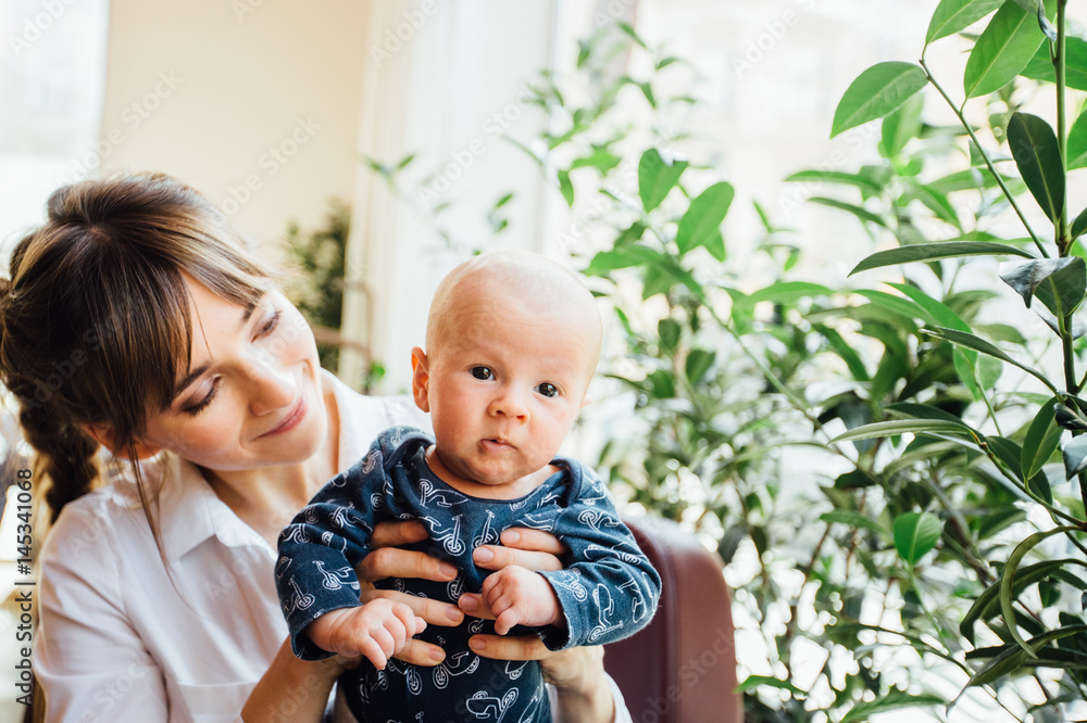 Happy young mother with cute baby boy indoors Happy young mother with cute baby boy indoors