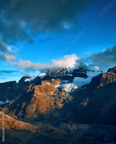 beautifull cloudy sunrise in the mountains with snow ridge. Alps. Switzerland, Trek near Matterhorn mount. © vitaliymateha