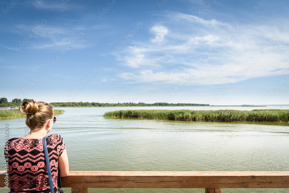 Fototapeta premium Tourist at lake pier