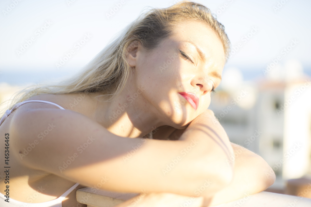 Sunny Blond girl with light clothing in white color next to mediterranean sea in the city of Marbella, spain Sunny Blond girl with light clothing in white color next to mediterranean sea in the city of Marbella, spain