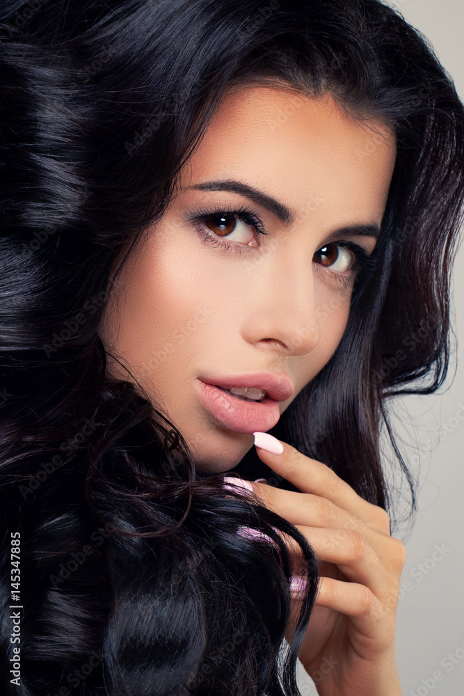 Perfect Brunette Woman with Dark Curly Hairstyle and Makeup. Cute Face Closeup Perfect Brunette Woman with Dark Curly Hairstyle and Makeup. Cute Face Closeup