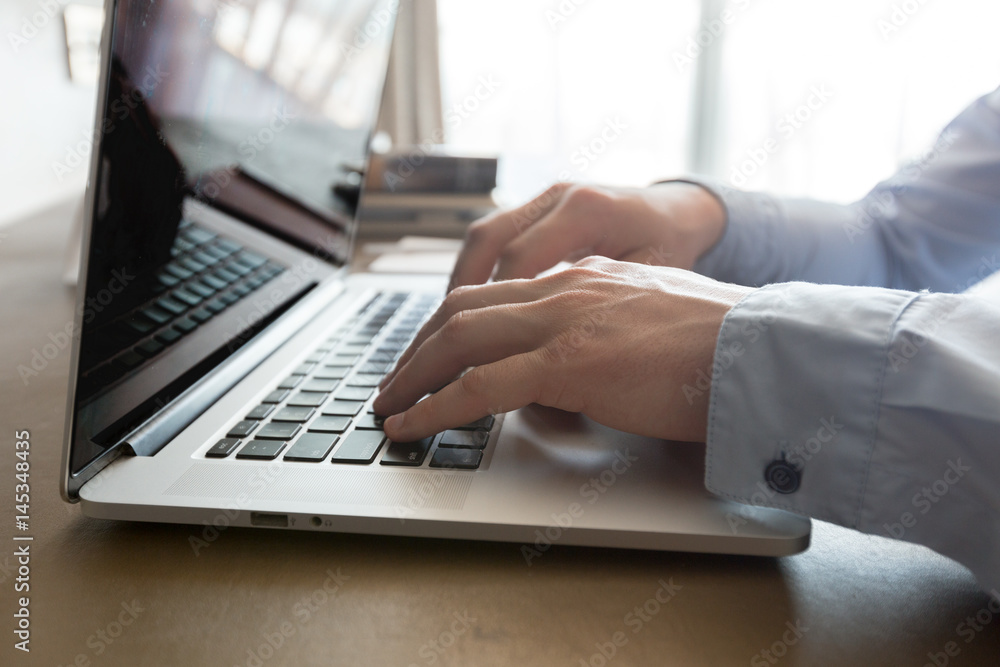 Caucasian man using laptop at table Caucasian man using laptop at table