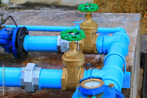 Photos water valve plumbing joint  steel tap pipe with green knob close up