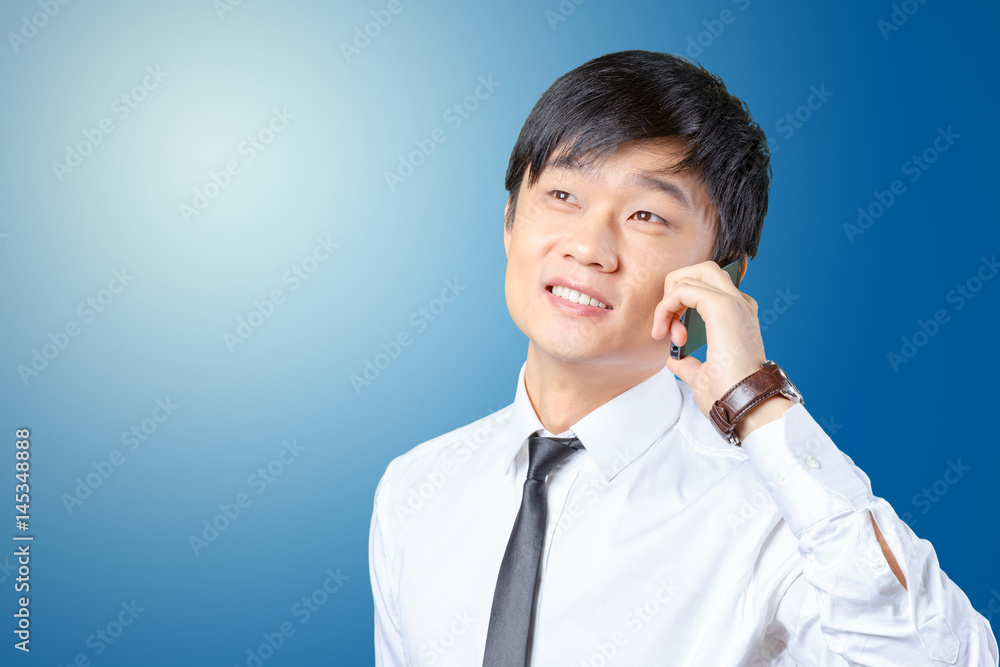 Asian businessman talking on mobile cell phone Asian businessman talking on mobile cell phone