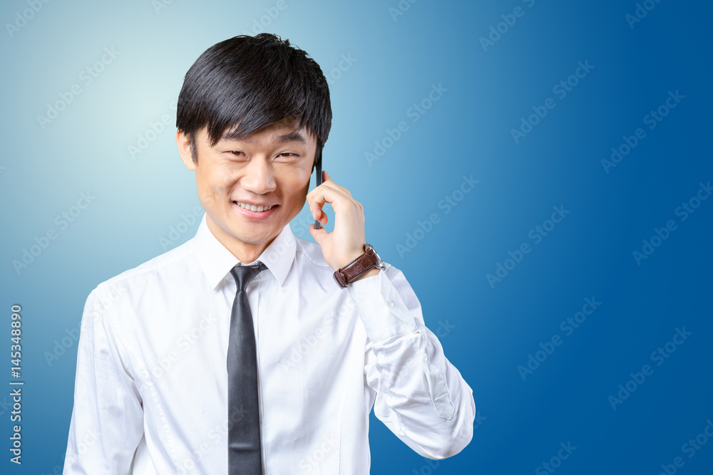 Asian businessman talking on mobile cell phone Asian businessman talking on mobile cell phone