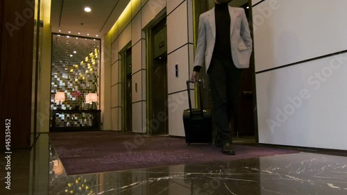 Attractive young man getting out of hotel lift