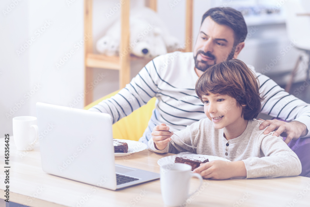 Positive son and father spending time in family circle Positive son and father spending time in family circle