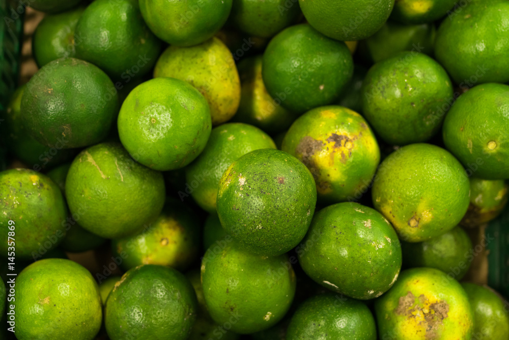 Bunch of fresh green mandarin in the organic food market. Tropical Bali island, Indonesia. Bunch of fresh green mandarin in the organic food market. Tropical Bali island, Indonesia.