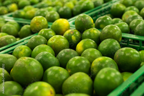 Bunch of fresh green mandarin in the organic food market. Tropical Bali island  Indonesia.