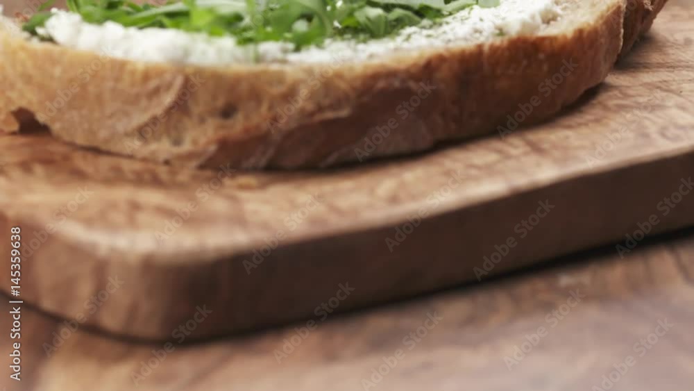 Slow motion pan of sandwich with arugula and ricotta cheese, prores footage Slow motion pan of sandwich with arugula and ricotta cheese, prores footage