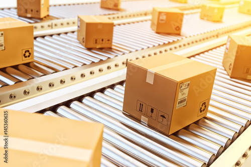 Packages delivery, packaging service and parcels transportation system concept, cardboard boxes on conveyor belt in warehouse