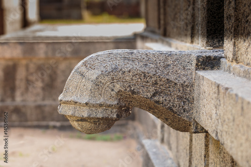 Water spout in stone at Hindu temple in South India photo