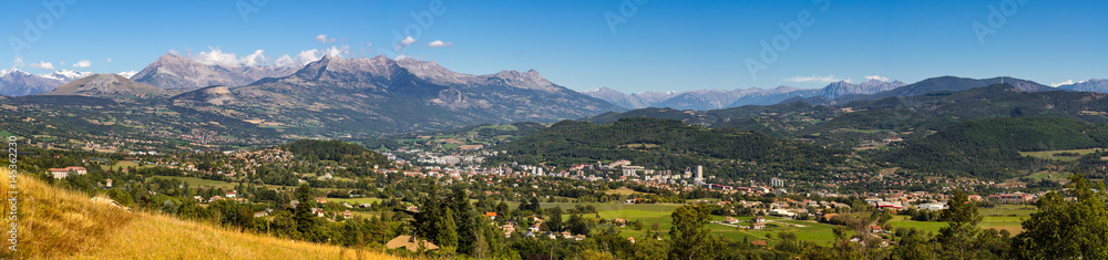 Panoramic summer view of the city of Gap in the Hautes Alpes with surrounding mountains and peaks. Southern French Alps, Paca region, France