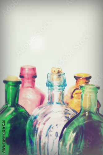 Old colourful bottles against a white background