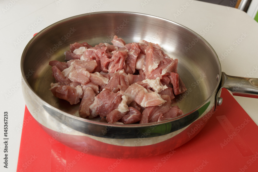 Pork in a hot steel frying pan Pork in a hot steel frying pan