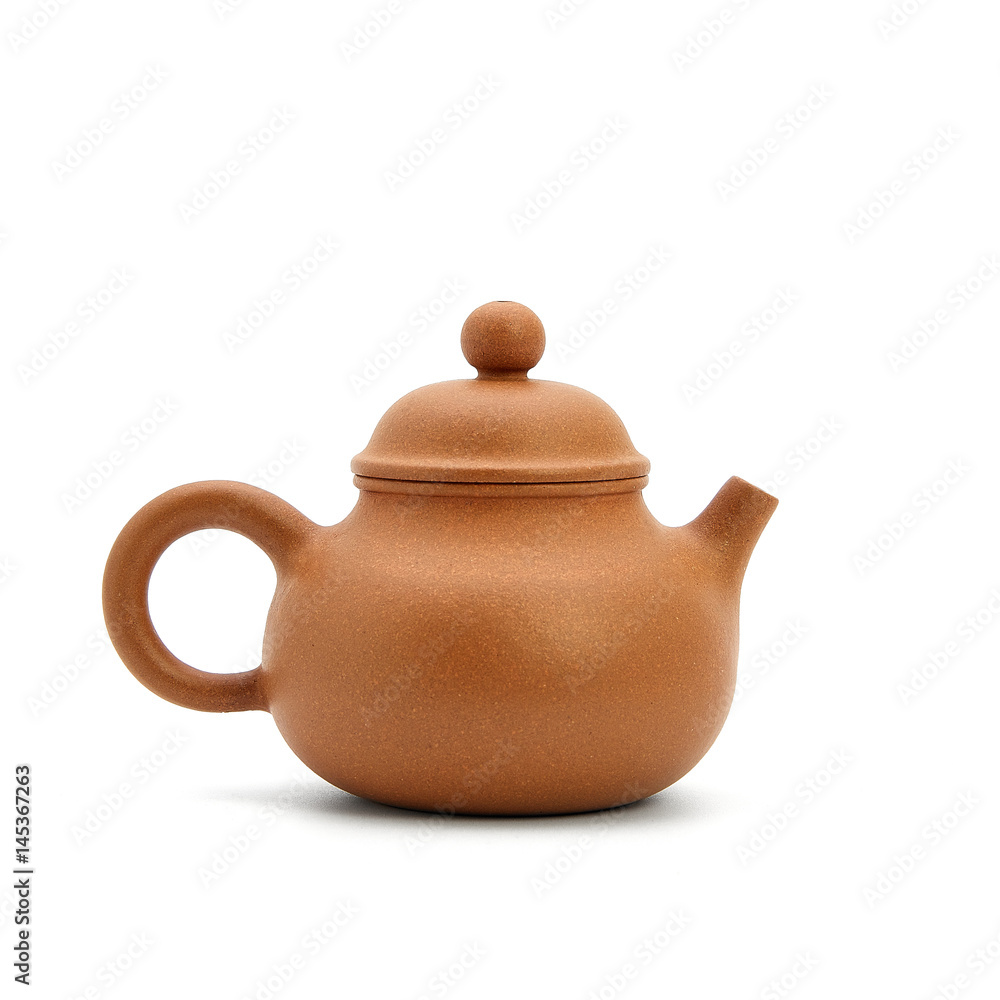 small earthenware teapot, bowl and tea on white background small earthenware teapot, bowl and tea on white background