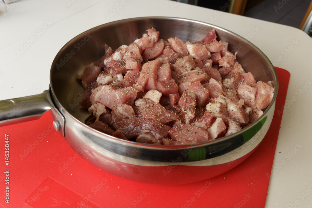 Fresh raw pork with spicy in a hot steel frying pan Fresh raw pork with spicy in a hot steel frying pan
