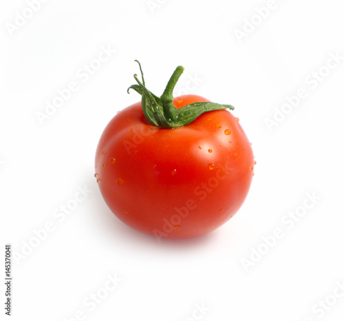 Photo depicts a bright red color natural beautiful delicious single fresh tomato with water drops, isolated on a white background. Washed vegetable concept. Close up, top view.