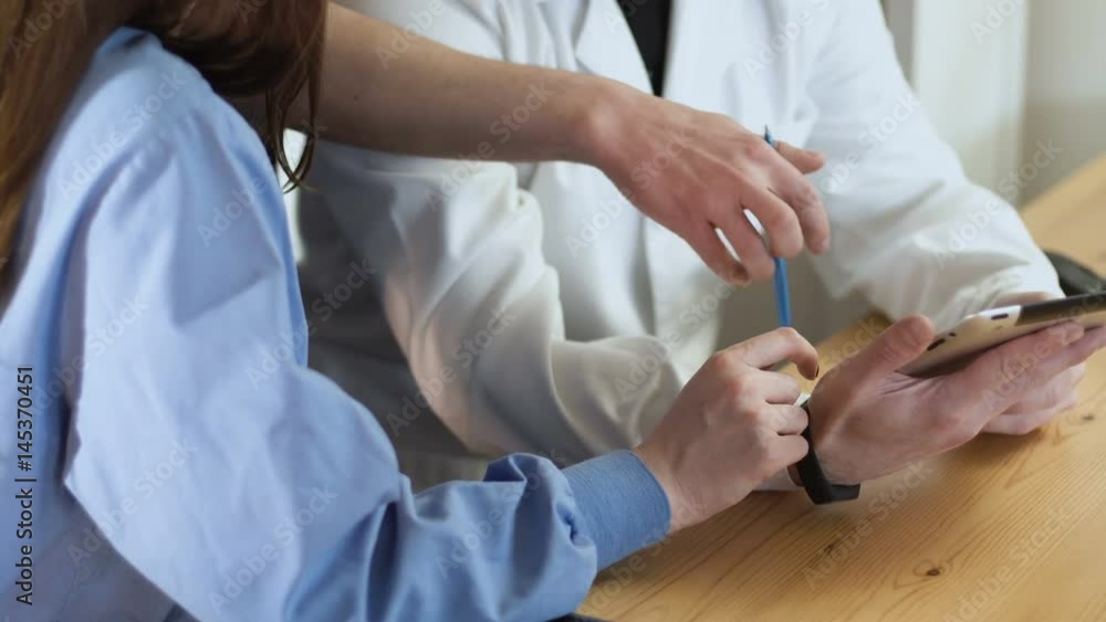 close up of a tablet in a doctors hands discussing medical team work consultation. they indicates by finger on a touch screen 4k close up of a tablet in a doctors hands discussing medical team work consultation. they indicates by finger on a touch screen 4k