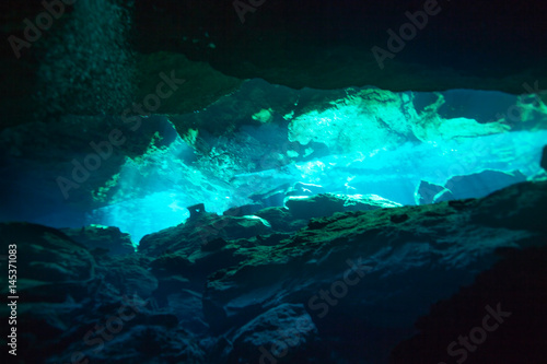 View on underwater rocks in cenote blue water