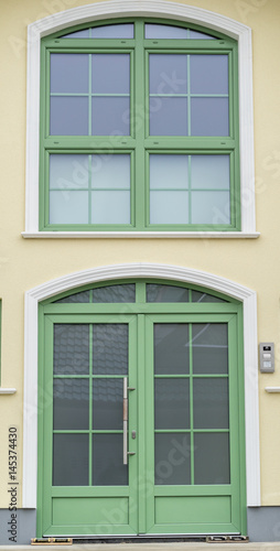 Grüne Haustür mit Glas und einem grünen Fenster
