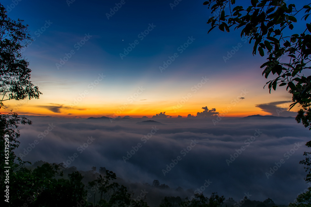 Beautiful summer sunrise on the top of mountain with Rays of Light, fog and cloud mountain