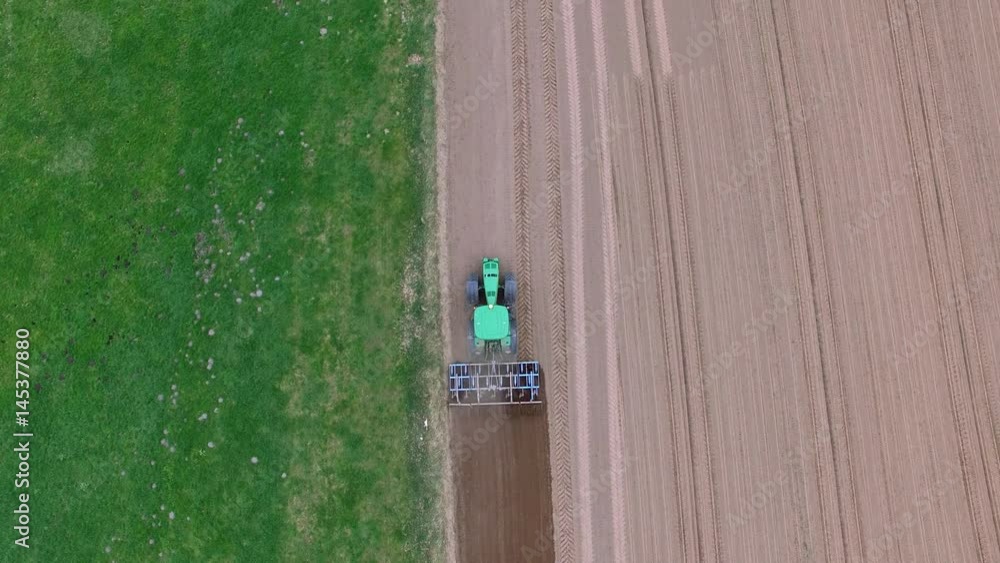 tractor - aerial view of a tractor at work - cultivating a field in spring - agricultural machinery tractor - aerial view of a tractor at work - cultivating a field in spring - agricultural machinery