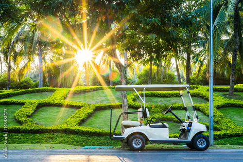 golf car in the garden at sunset