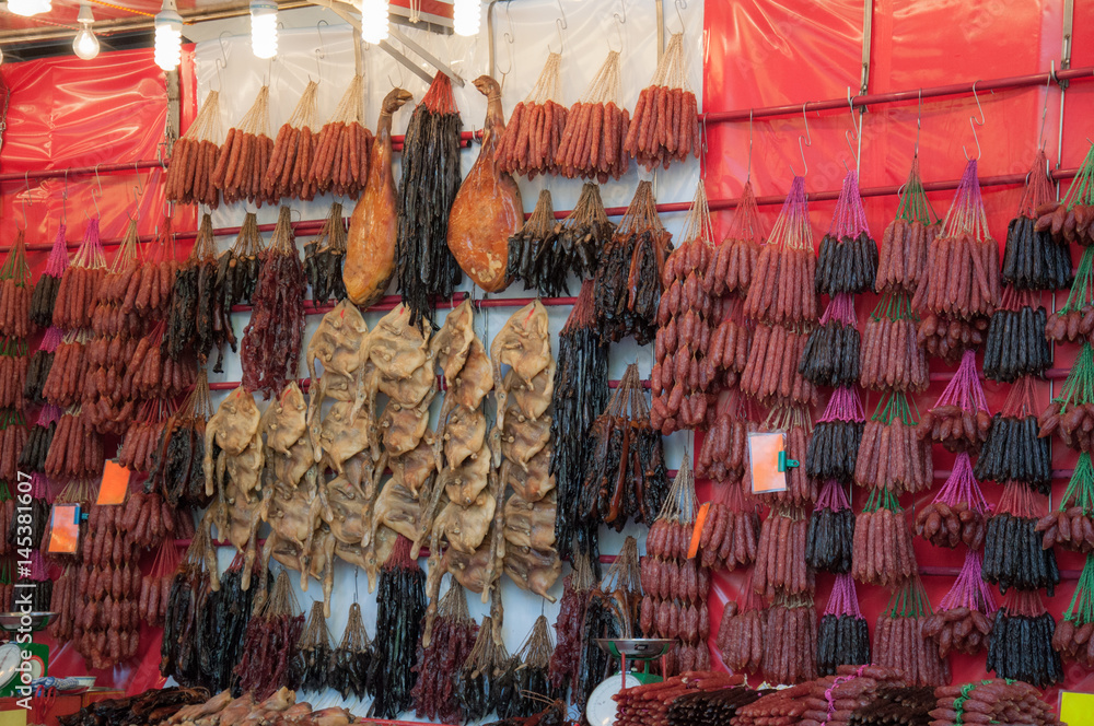 Chinese sausages and duck dry, hung from the shelves in the market.