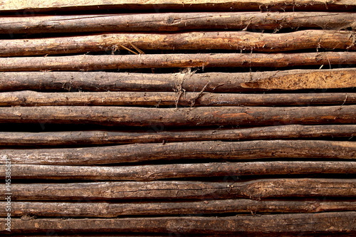 old wooden fence of logs in form of palisade