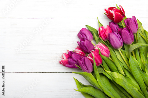 Tulip bouquet on white wooden background, copy space