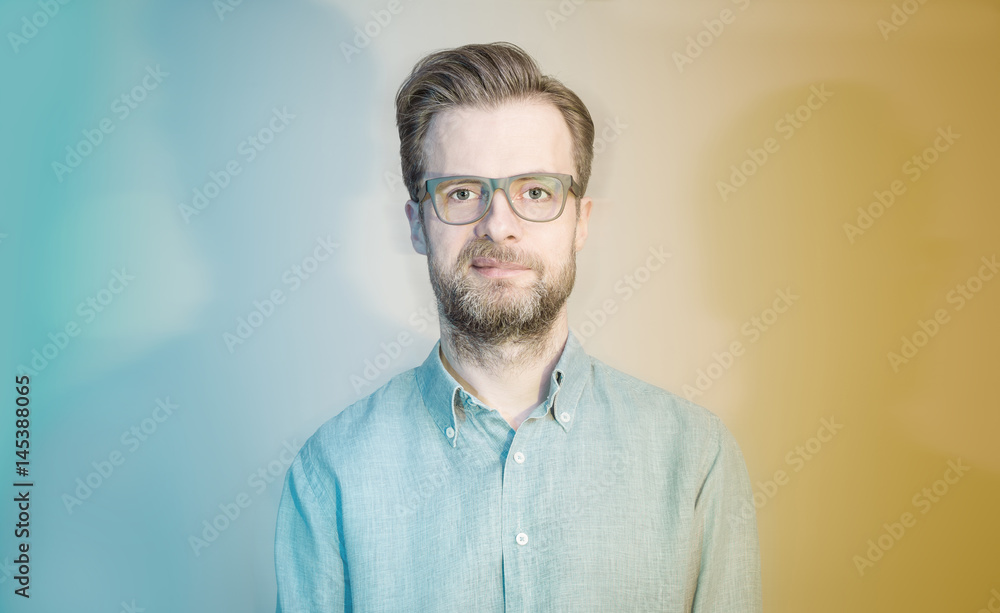 Obraz premium Colorful portrait of caucasian bearded man in glasses