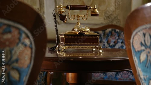 Luxury interior – vintage telephone on table and armchairs
