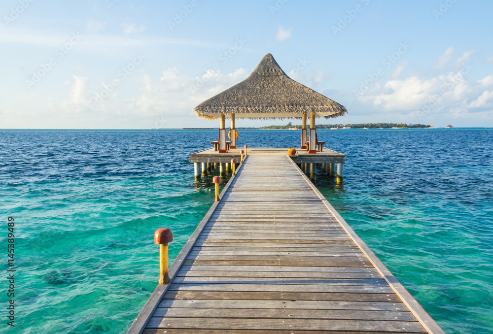 Wooden pier on a tropical beach in the Maldives