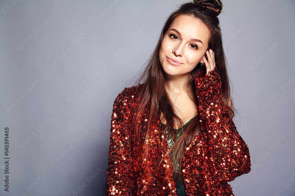 Beautiful caucasian smiling hipster brunette woman model in bright shinny reflecting summer stylish jacket and green dress posing on gray background Beautiful caucasian smiling hipster brunette woman model in bright shinny reflecting summer stylish jacket and green dress posing on gray background