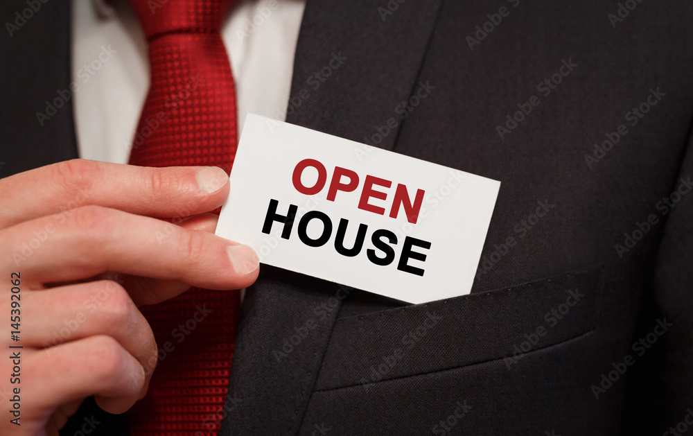 Businessman putting a card with text Open House in the pocket Businessman putting a card with text Open House in the pocket