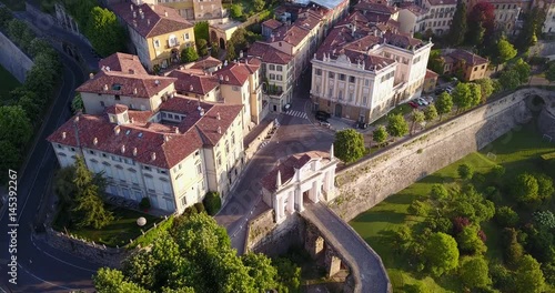 4K Drone aerial view of Bergamo - Old city (Città Alta). One of the beautiful city in Italy. Landscape on the old gate named Porta San Giacomo and historical buildings during a wonderful blu day