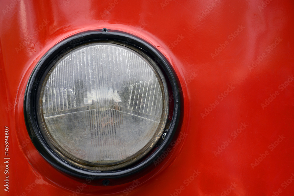 Round headlight of old tram closeup