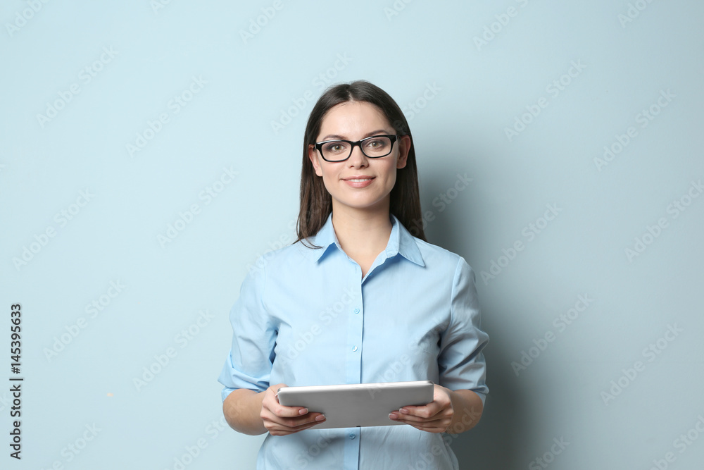 Young beautiful woman with tablet on light background Young beautiful woman with tablet on light background