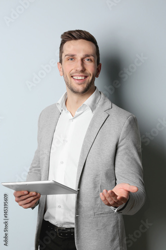 Young handsome man with tab...