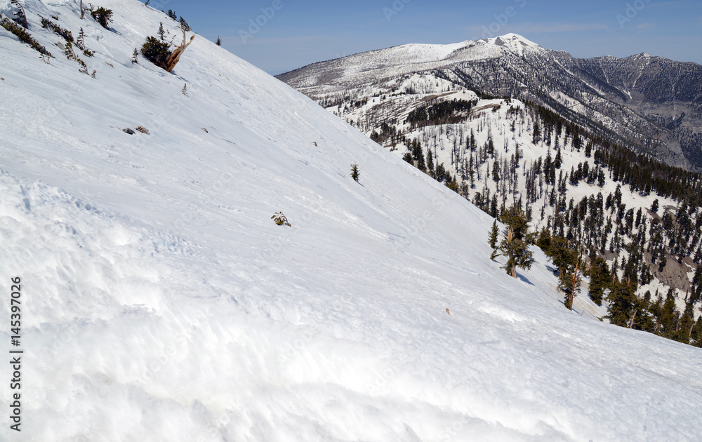 Steep angled slopes on mountain showing avalanche terrain, a major risk for skiing, hiking and climbing on mountains in fresh snow