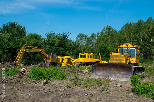 Mechanical Site Preparation for Forestry. Excavator and bulldozer clearing forest land.