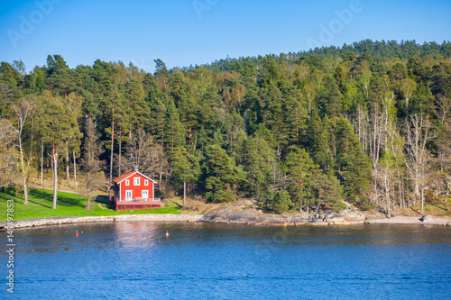 Coastal village with red wooden house