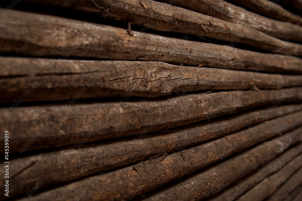 closeup old wooden fence of logs in form of palisade focus closeup old wooden fence of logs in form of palisade focus