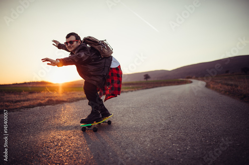 Young skater riding a skateboard outdoors on the street