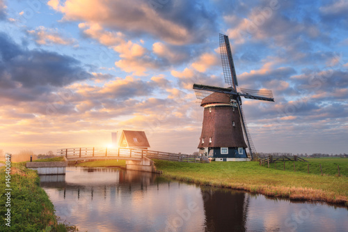 Fotografija Windmill near the water canal at sunrise in Netherlands