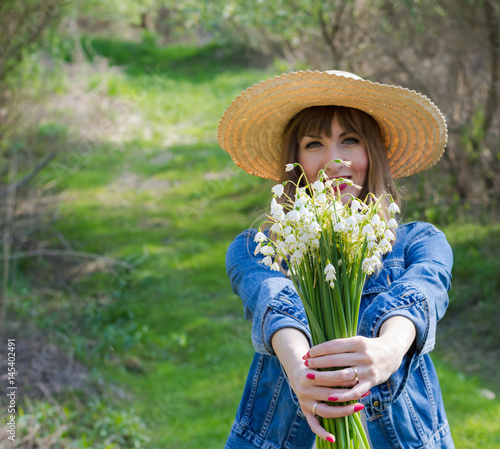Lily of the valley in hands of beautiful girl